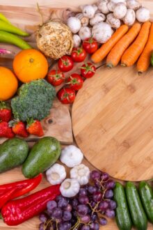 Fresh raw fruits and vegetables that support healthy skin through diet