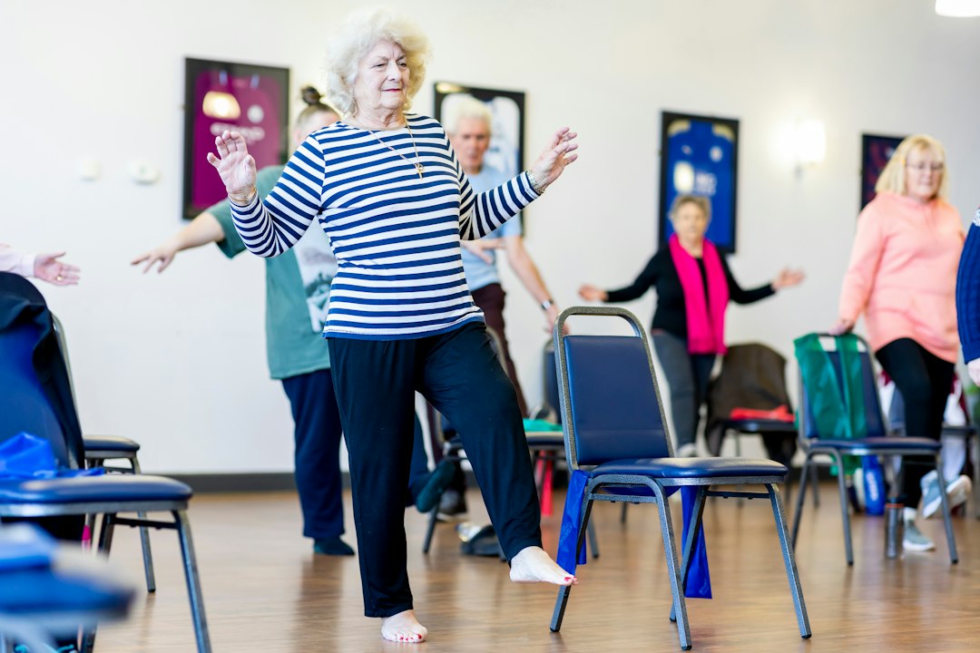 Older women taking part in a gentle indoor exercise class