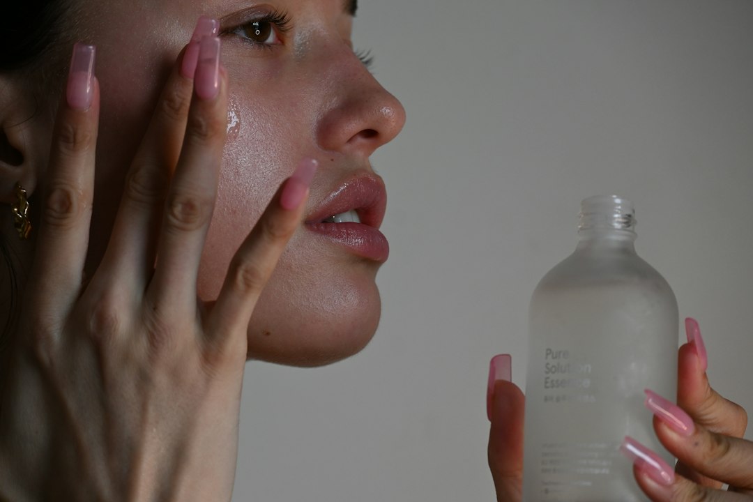 Person applying a skincare product to their cheek